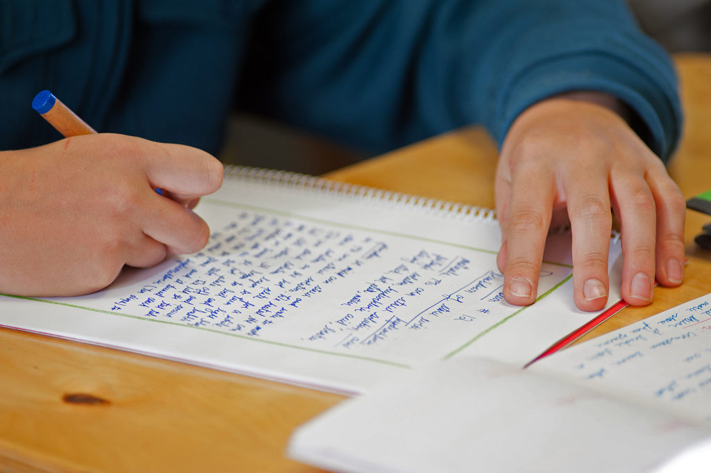 Students leave a border on their writings so they will be able to add in artistic details later on.