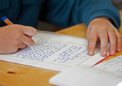 Students leave a border on their writings so they will be able to add in artistic details later on.