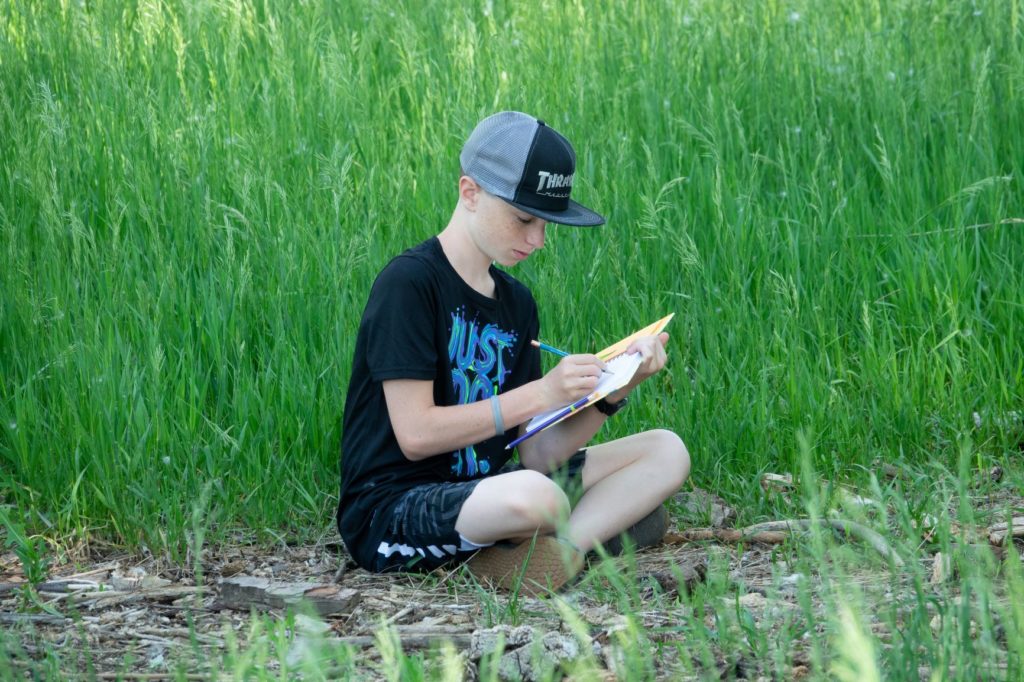 Students often spend time outside reading, writing, or drawing on Boulder Valley Waldorf's 38 acres campus.